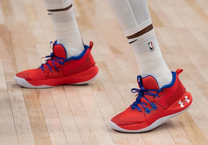 View of red, white, and blue Under Armour shoes.